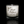 A white candle in a clear glass candle holder by Scents of Purpose on a black background.